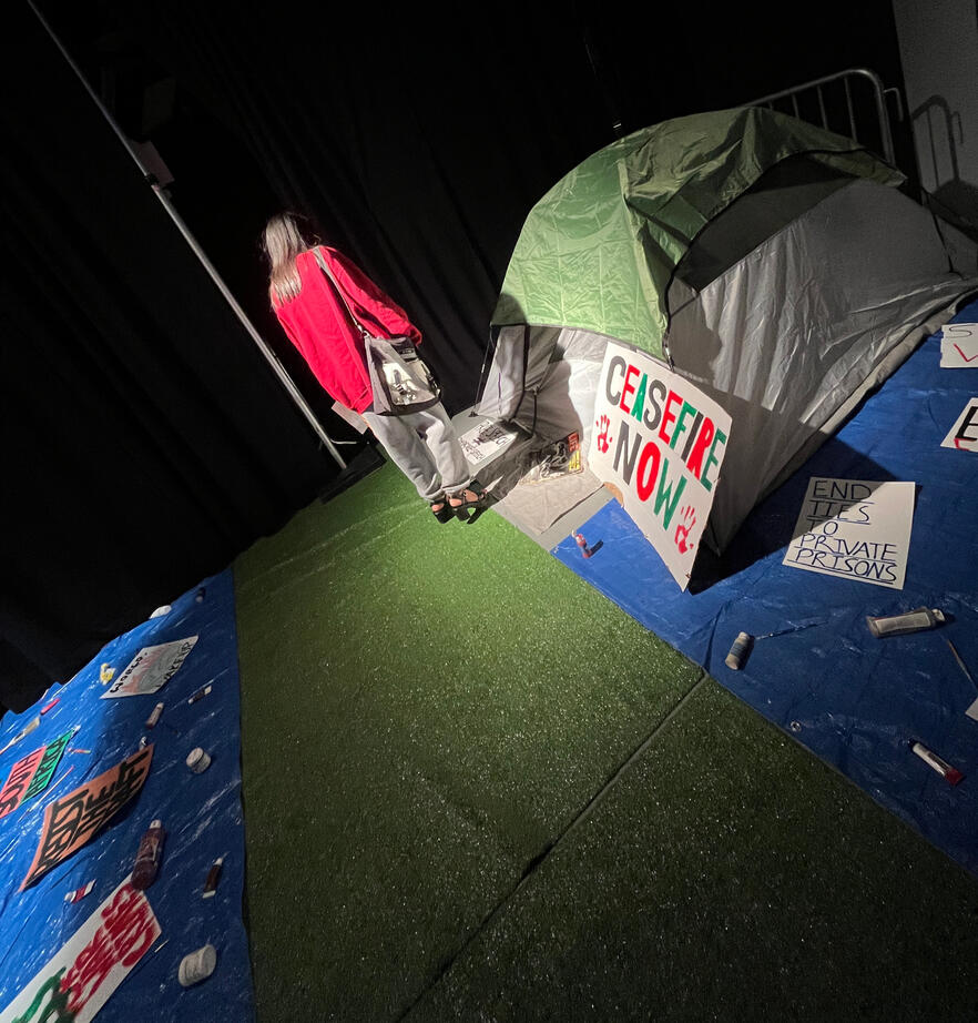 A student walking through the protest section. We recreated signs from historical university protests.